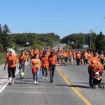crowd in orange t-shirts
