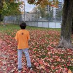 child in orange shirt